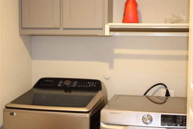 washroom with cabinets and separate washer and dryer