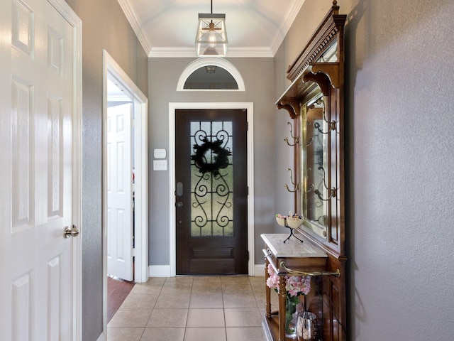 entryway with light tile patterned floors and ornamental molding