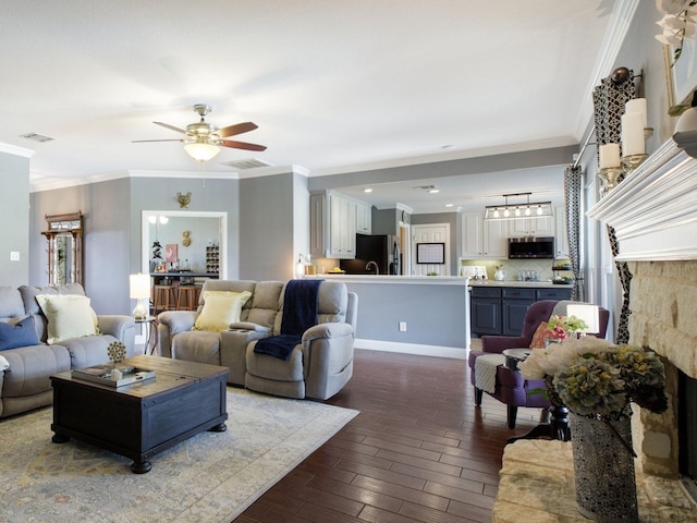 living room with ceiling fan and ornamental molding