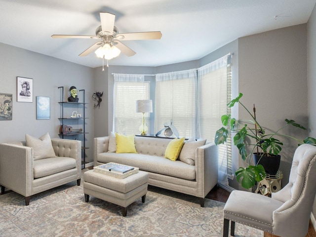 living room featuring ceiling fan and hardwood / wood-style floors