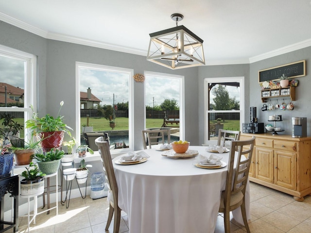 dining area with a healthy amount of sunlight, light tile patterned floors, ornamental molding, and a notable chandelier