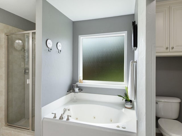 bathroom with separate shower and tub, toilet, and a wealth of natural light