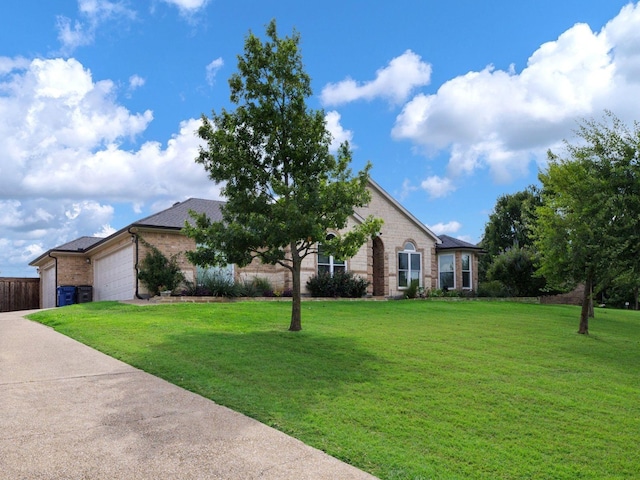 ranch-style home with a front yard and a garage