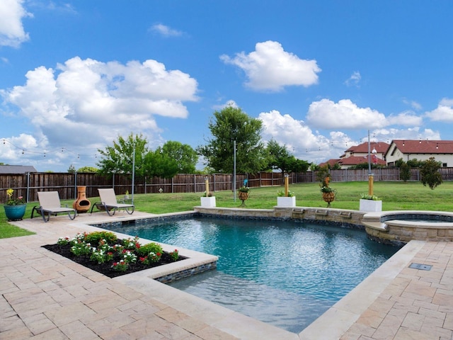 view of swimming pool with an in ground hot tub, a patio, and a lawn