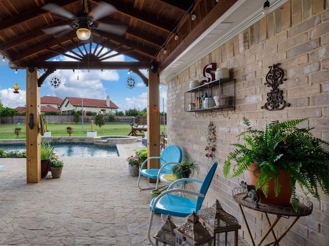 view of patio / terrace featuring a gazebo, ceiling fan, and a pool with hot tub