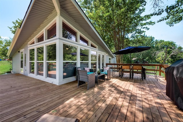 wooden deck with a sunroom and an outdoor hangout area