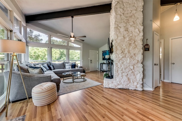 living room with light wood-type flooring, beamed ceiling, and high vaulted ceiling