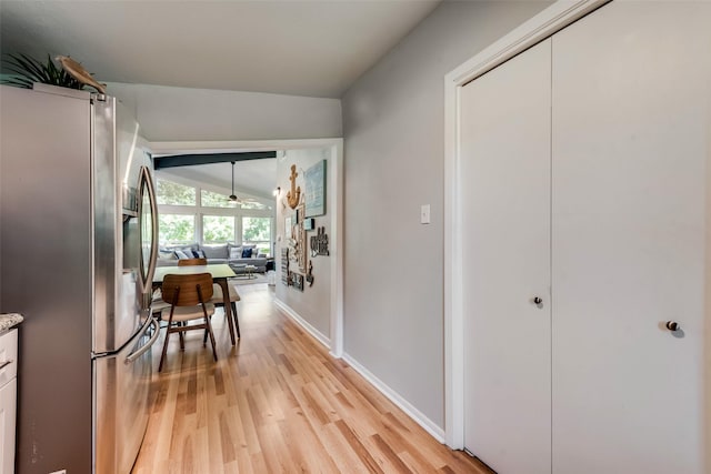 corridor featuring light hardwood / wood-style floors and vaulted ceiling