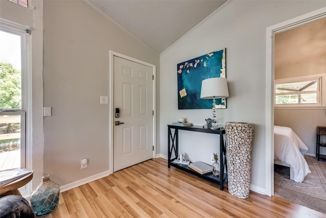 entryway with light wood-type flooring and lofted ceiling