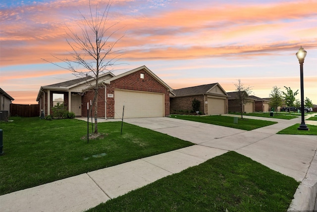 ranch-style house with a garage, central AC unit, and a lawn