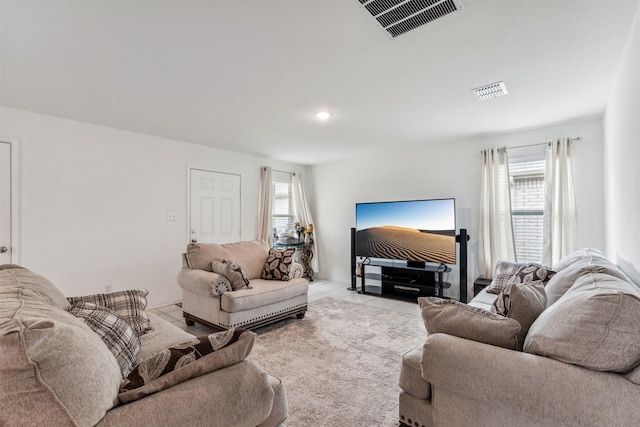 tiled living room with a healthy amount of sunlight