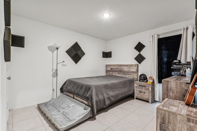 bedroom with light tile patterned floors