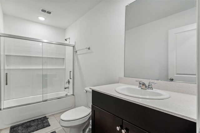 full bathroom featuring tile patterned floors, vanity, toilet, and shower / bath combination with glass door