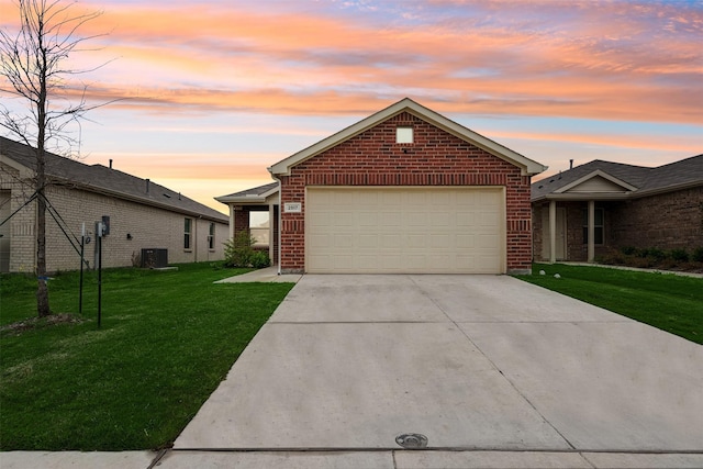 ranch-style home with central AC unit, a garage, and a lawn