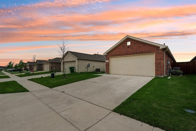 ranch-style house with a lawn and a garage