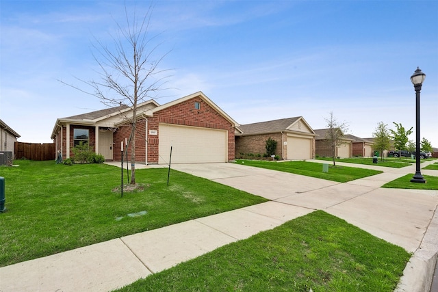 ranch-style house with central AC unit, a garage, and a front yard