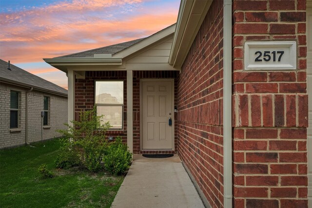 view of exterior entry at dusk