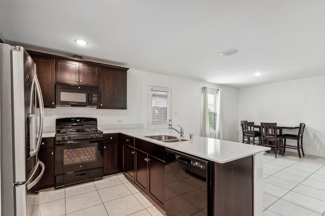 kitchen with sink, kitchen peninsula, dark brown cabinets, light tile patterned flooring, and black appliances