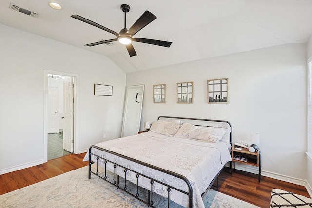 bedroom featuring dark hardwood / wood-style floors, vaulted ceiling, and ceiling fan