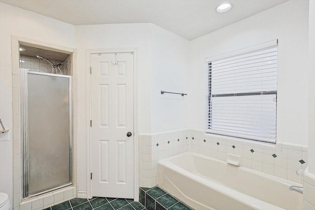 bathroom featuring tile patterned flooring, toilet, and plus walk in shower