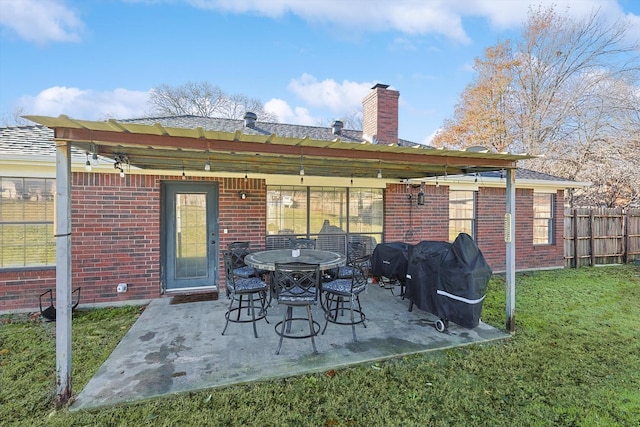 rear view of property featuring a patio area and a yard