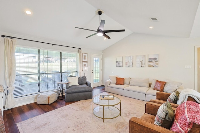 living room with ceiling fan, vaulted ceiling, and hardwood / wood-style flooring