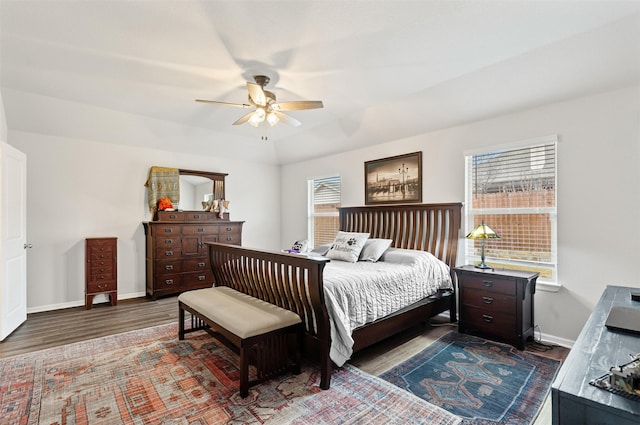 bedroom with hardwood / wood-style flooring, ceiling fan, and multiple windows