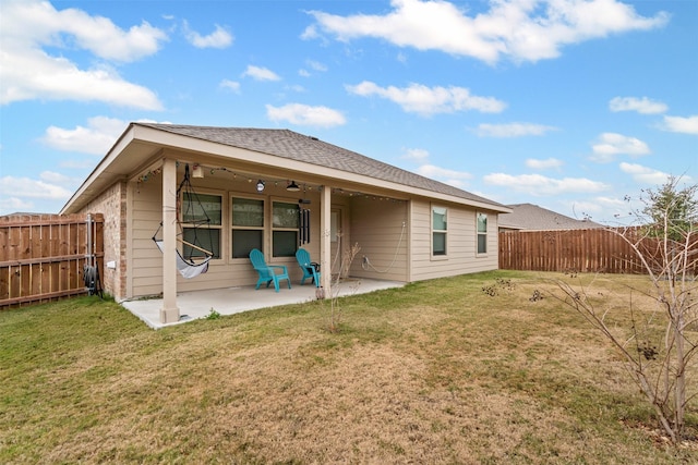 back of house with a yard, a patio, and ceiling fan