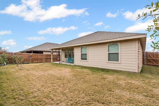 rear view of house with a lawn and a patio area