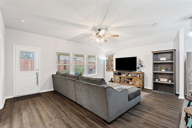 living room featuring ceiling fan, dark wood-type flooring, and vaulted ceiling