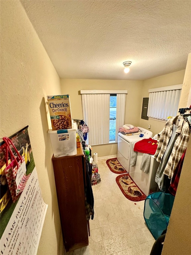 bedroom featuring washing machine and dryer and a textured ceiling