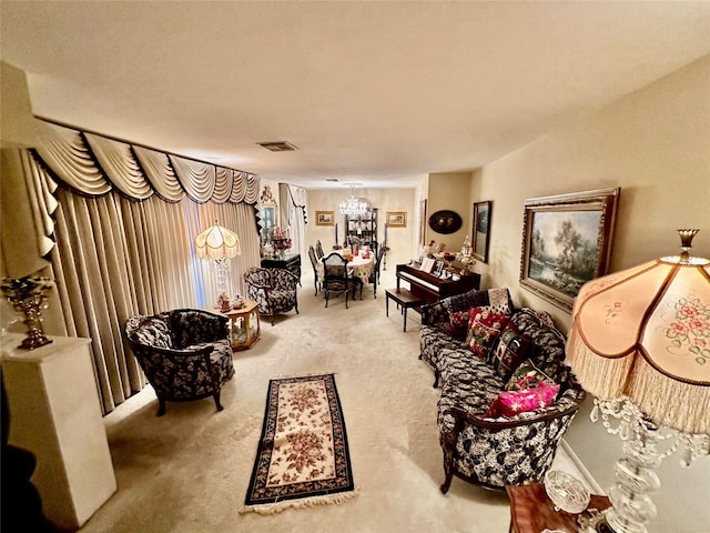 carpeted living room with a chandelier