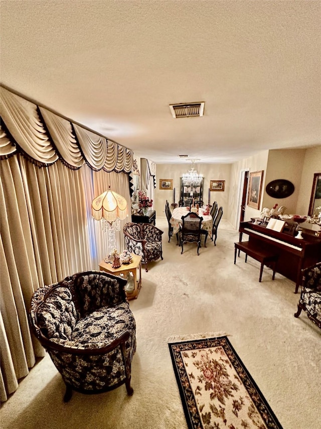 sitting room featuring carpet flooring, a chandelier, and a textured ceiling