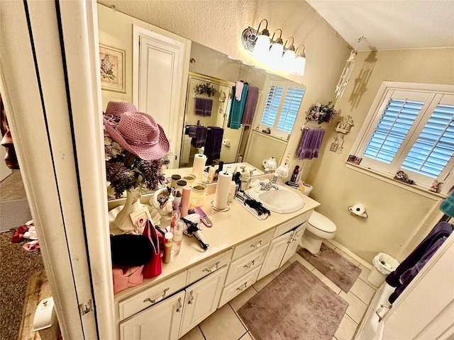 bathroom featuring vanity, an enclosed shower, tile patterned floors, and toilet