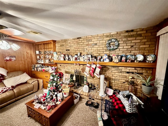 living room with a fireplace, carpet, and a textured ceiling