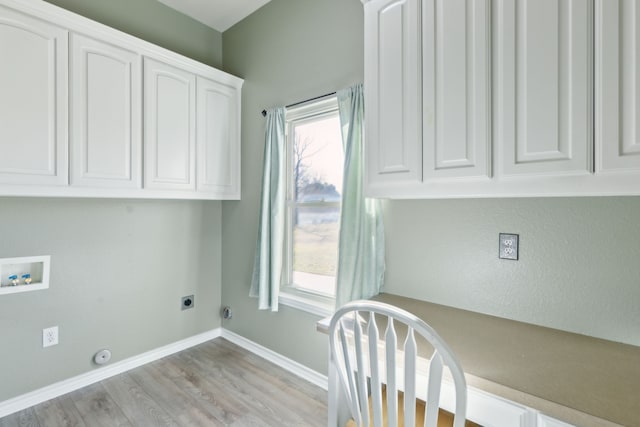 laundry area featuring cabinets, a healthy amount of sunlight, hookup for an electric dryer, and hookup for a washing machine