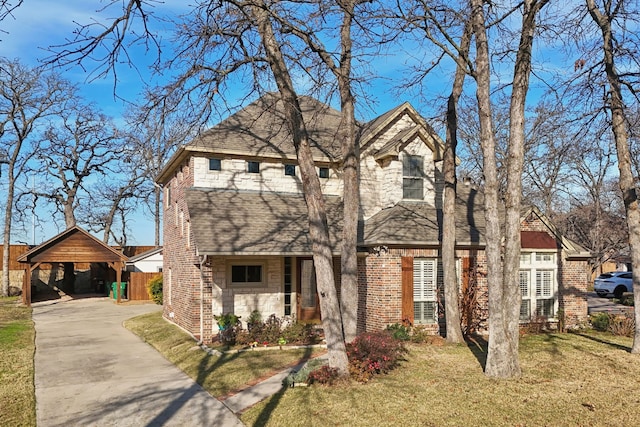 view of front facade featuring a carport and a front yard