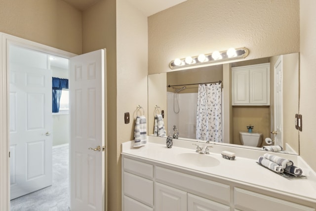 bathroom with vanity, toilet, and a shower with shower curtain