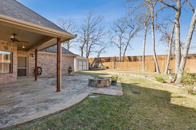 view of yard with a patio area, ceiling fan, and an outdoor fire pit