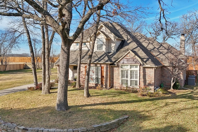 view of front facade with central AC and a front yard