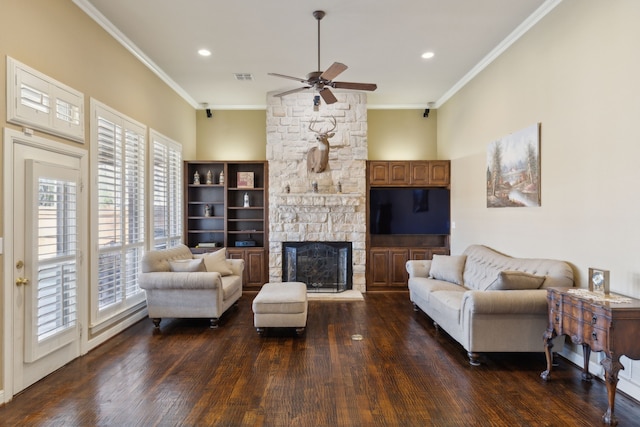 living room featuring ornamental molding, dark wood-type flooring, ceiling fan, and a fireplace