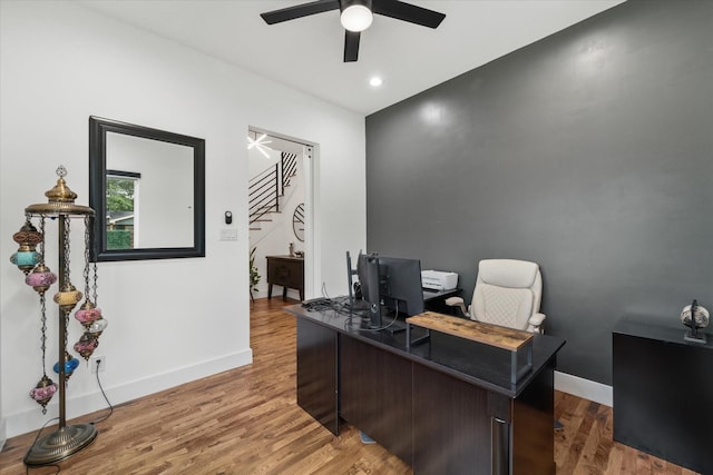 home office featuring hardwood / wood-style floors and ceiling fan