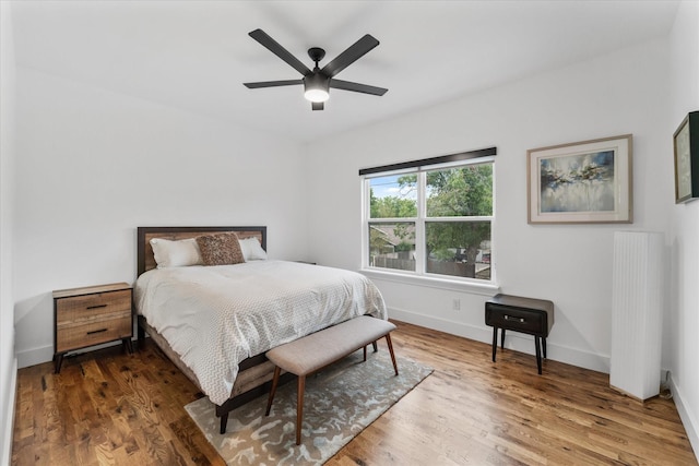 bedroom with ceiling fan and dark hardwood / wood-style floors