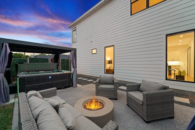 patio terrace at dusk featuring an outdoor living space with a fire pit