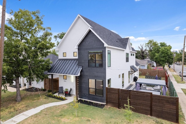 exterior space with central AC and a lawn