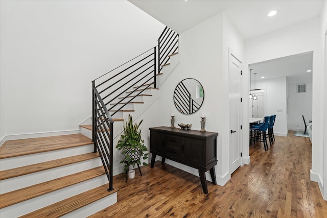 stairway with hardwood / wood-style flooring