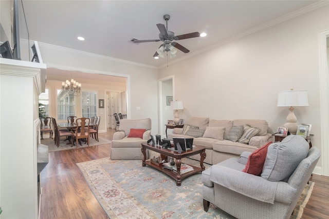 living room featuring dark hardwood / wood-style flooring, ceiling fan with notable chandelier, and ornamental molding