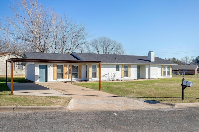 ranch-style home with a front yard and a carport