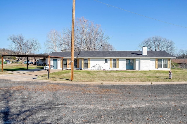 ranch-style home with a front yard and a carport