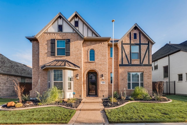 tudor home featuring a front lawn